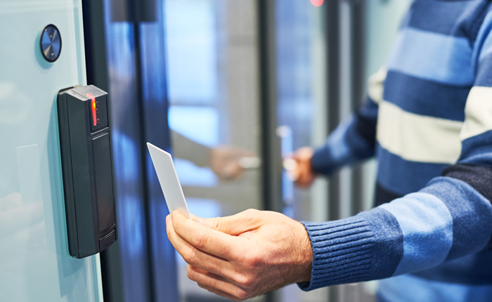 person using access control card to open a secure door modern security technology